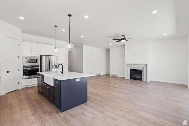 kitchen featuring a sink, light countertops, ceiling fan, recessed lighting, and stainless steel appliances