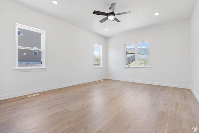 spare room featuring visible vents, baseboards, ceiling fan, light wood-style floors, and recessed lighting