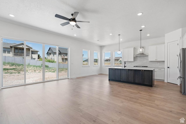kitchen with white cabinets, recessed lighting, decorative backsplash, and ceiling fan