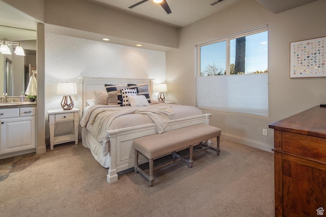 bedroom with ceiling fan, sink, and light carpet