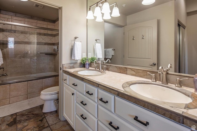 full bathroom with shower / bath combination with glass door, vanity, and toilet