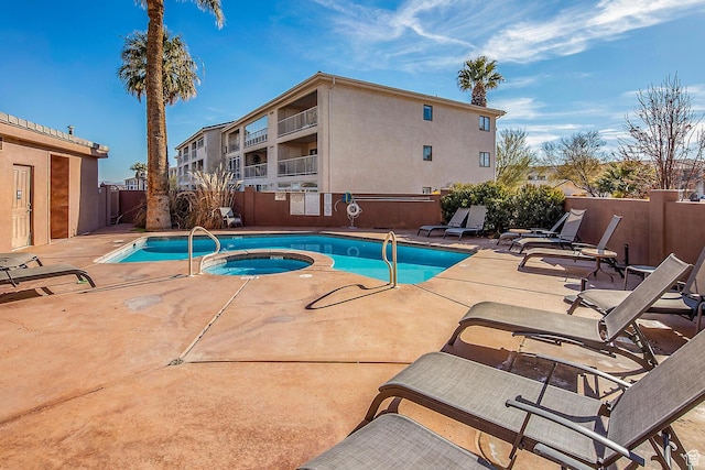 view of swimming pool with a patio area and a community hot tub