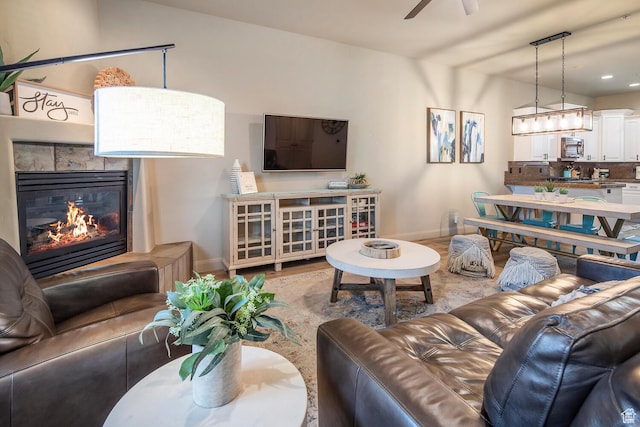 living room with hardwood / wood-style flooring and ceiling fan