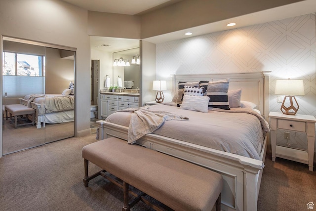 bedroom featuring carpet floors, connected bathroom, and a closet