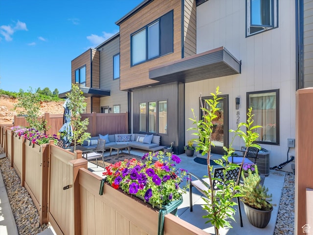 rear view of house featuring a patio and an outdoor hangout area