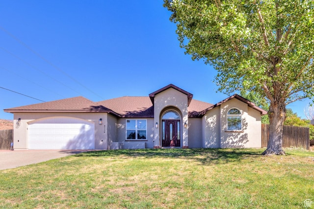 4119 Valle Del Sol Dr, Moab, UT 84532 - view of front of home with stucco siding, driveway, an attached garage, a front yard, and fence