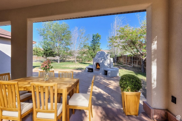4119 Valle Del Sol Dr, Moab, UT 84532 - view of patio featuring fence, an outdoor fireplace, and outdoor dining space