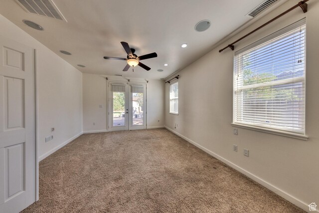4119 Valle Del Sol Dr, Moab, UT 84532 - unfurnished room featuring baseboards, visible vents, light colored carpet, and a ceiling fan