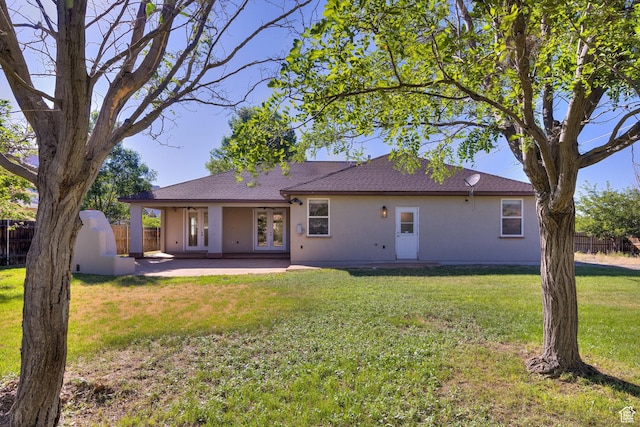 4119 Valle Del Sol Dr, Moab, UT 84532 - back of property featuring a patio, stucco siding, french doors, fence, and a lawn