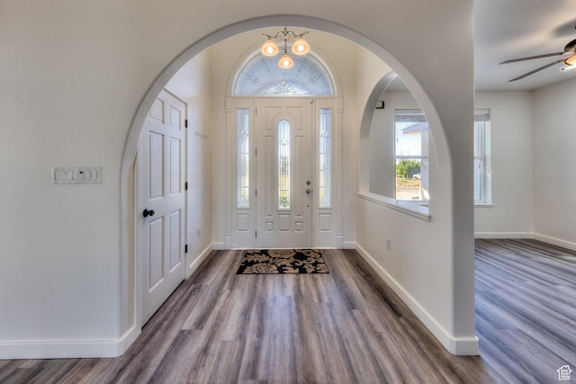 4119 Valle Del Sol Dr, Moab, UT 84532 - foyer entrance with dark wood-type flooring, ceiling fan, arched walkways, and baseboards