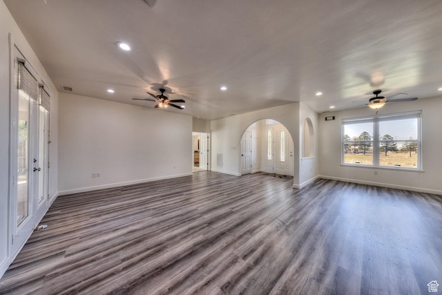 4119 Valle Del Sol Dr, Moab, UT 84532 - unfurnished living room featuring arched walkways, dark wood-style flooring, a ceiling fan, and recessed lighting