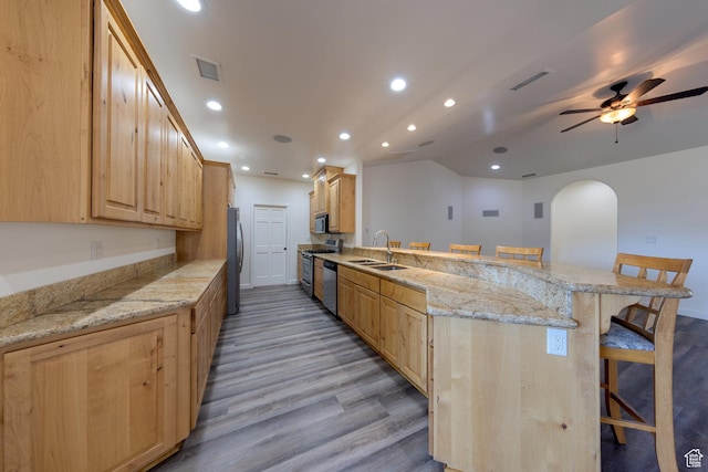 4119 Valle Del Sol Dr, Moab, UT 84532 - kitchen featuring visible vents, a breakfast bar, a sink, and appliances with stainless steel finishes