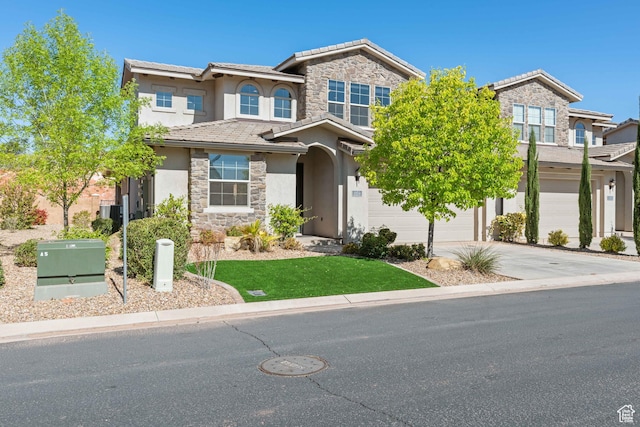 view of front of property featuring concrete driveway, stone siding, a tiled roof, an attached garage, and stucco siding