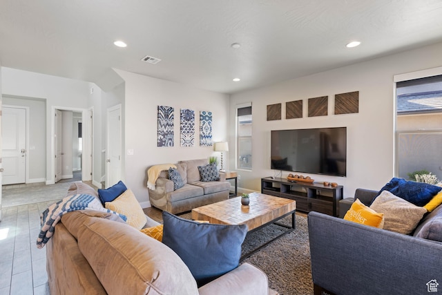 living area featuring recessed lighting, visible vents, and baseboards