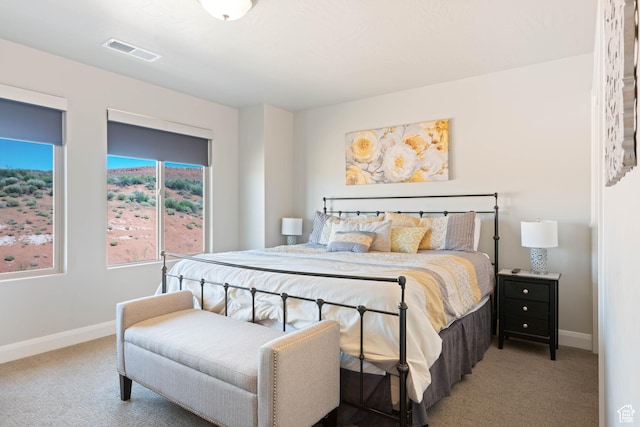 bedroom featuring carpet floors, visible vents, and baseboards