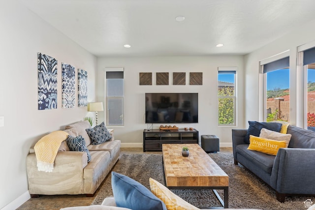living area with baseboards and recessed lighting