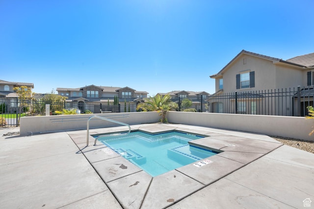 view of pool featuring fence private yard, a patio area, and a residential view