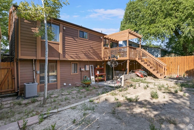 back of house with a pergola and a wooden deck