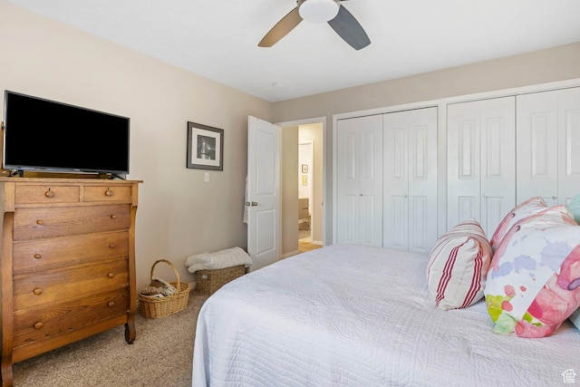 carpeted bedroom with multiple closets and ceiling fan
