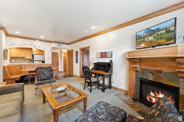 carpeted living room featuring a stone fireplace and crown molding