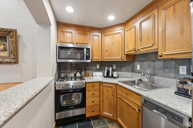 kitchen with decorative backsplash, stainless steel appliances, and sink