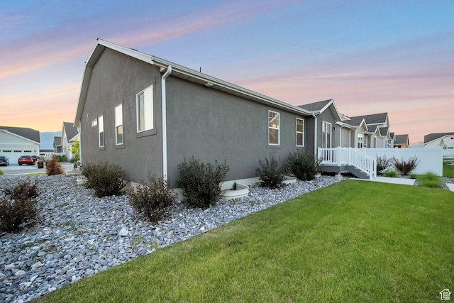 6618 N Furner Rdg, Eagle Mountain, UT 84005 - property exterior at dusk featuring a lawn