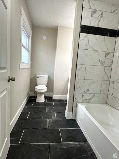 3715 W 11500 N, Neola, UT 84053 - bathroom with toilet, a textured ceiling, and tiled shower / bath