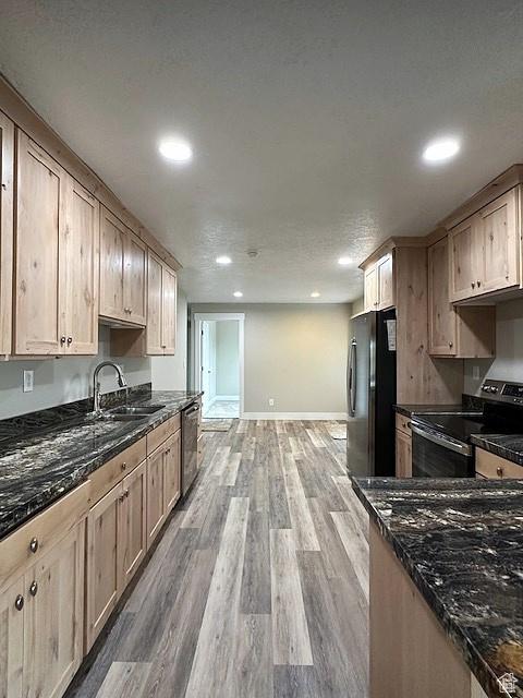 3715 W 11500 N, Neola, UT 84053 - kitchen featuring light brown cabinetry, appliances with stainless steel finishes, wood-type flooring, sink, and dark stone counters