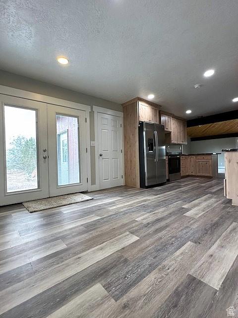 3715 W 11500 N, Neola, UT 84053 - kitchen featuring a textured ceiling, light hardwood / wood-style flooring, stainless steel appliances, and french doors