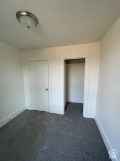 38 E 500 N, Tooele, UT 84074 - unfurnished bedroom featuring baseboards and dark carpet