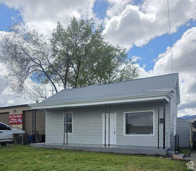 back of house with a yard and fence