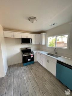38 E 500 N, Tooele, UT 84074 - kitchen featuring appliances with stainless steel finishes, wood tiled floor, white cabinets, and a sink
