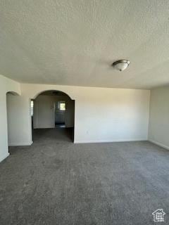 38 E 500 N, Tooele, UT 84074 - spare room with a textured ceiling, arched walkways, and carpet floors