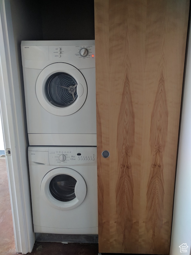 washroom featuring stacked washing maching and dryer