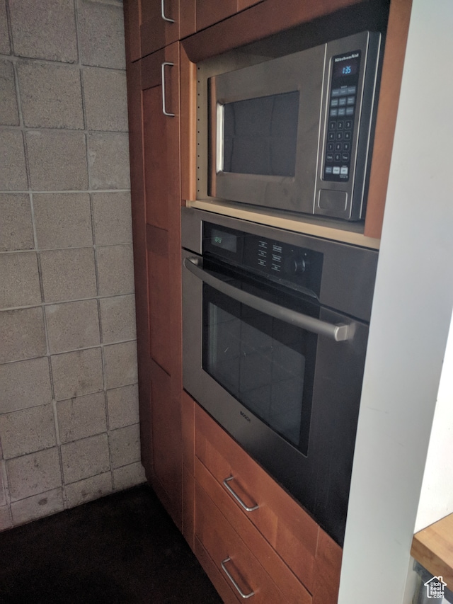 kitchen with appliances with stainless steel finishes and a paneled ceiling