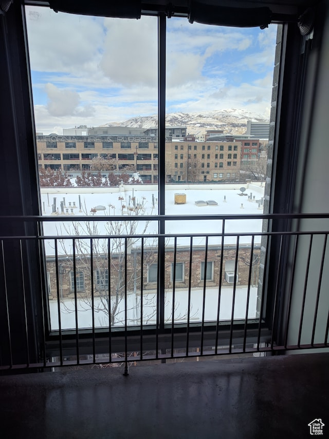 snow covered back of property with a mountain view