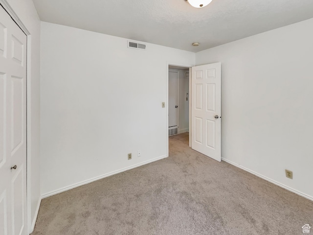 1227 Riverside Ave Unit 50, Provo, UT 84604 - unfurnished bedroom featuring light carpet and a textured ceiling