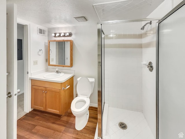1227 Riverside Ave Unit 50, Provo, UT 84604 - bathroom featuring a textured ceiling, wood-type flooring, toilet, and walk in shower