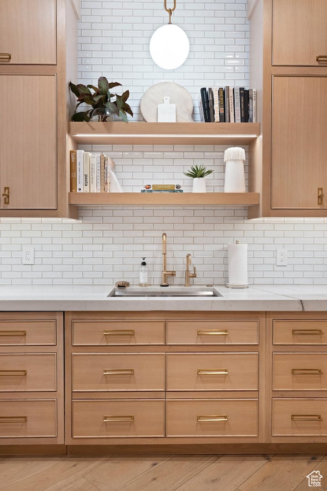 3905 S Quarry Ridge Dr, St George, UT 84790 - kitchen featuring light stone countertops, sink, pendant lighting, and light brown cabinetry