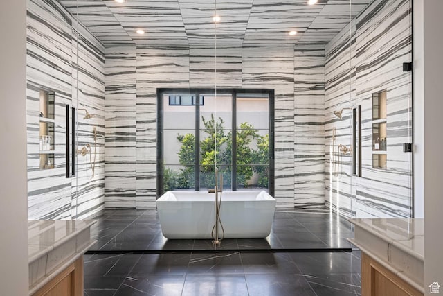 3905 S Quarry Ridge Dr, St George, UT 84790 - bathroom featuring tile walls, a bath, and tile patterned floors