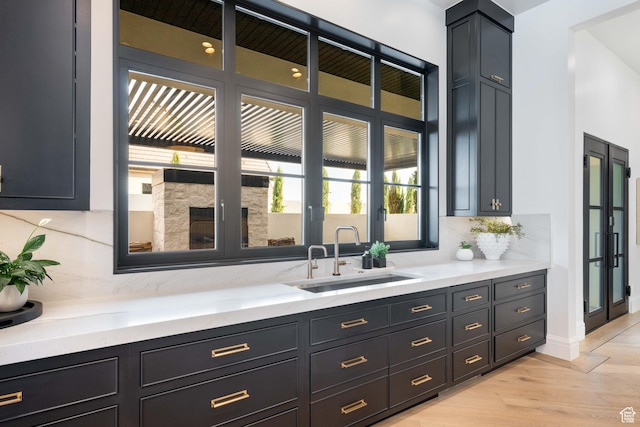 3905 S Quarry Ridge Dr, St George, UT 84790 - bar with sink, backsplash, and light hardwood / wood-style floors