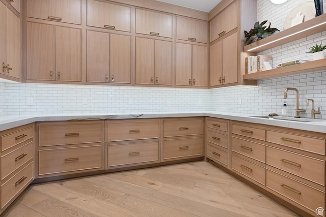 3905 S Quarry Ridge Dr, St George, UT 84790 - kitchen with tasteful backsplash, light brown cabinetry, sink, and light hardwood / wood-style flooring