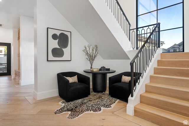3905 S Quarry Ridge Dr, St George, UT 84790 - stairway featuring a healthy amount of sunlight, hardwood / wood-style floors, and a high ceiling