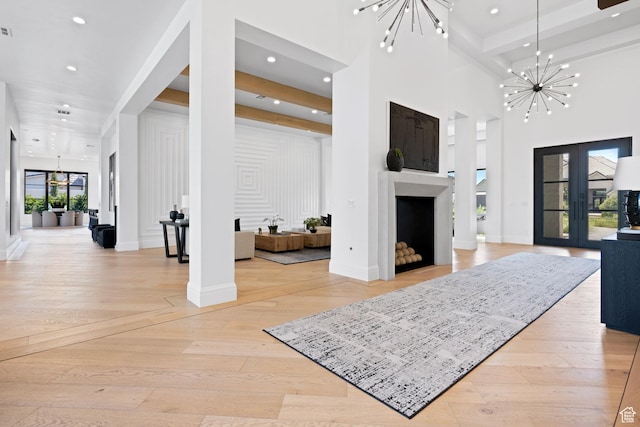3905 S Quarry Ridge Dr, St George, UT 84790 - entrance foyer featuring french doors, a towering ceiling, light hardwood / wood-style floors, and a notable chandelier