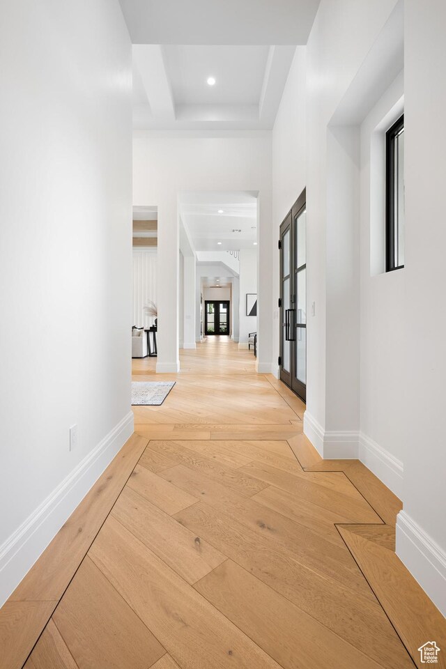 3905 S Quarry Ridge Dr, St George, UT 84790 - hall with a tray ceiling, light hardwood / wood-style flooring, french doors, and a towering ceiling