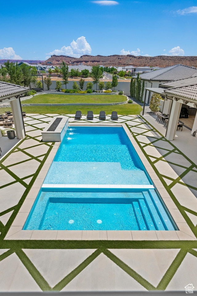 3905 S Quarry Ridge Dr, St George, UT 84790 - view of swimming pool featuring pool water feature, a patio area, a lawn, a pergola, and a mountain view