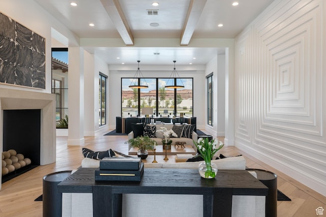 3905 S Quarry Ridge Dr, St George, UT 84790 - living room featuring beamed ceiling, decorative columns, and light wood-type flooring
