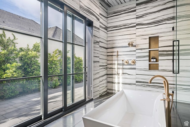 3905 S Quarry Ridge Dr, St George, UT 84790 - bathroom with a tub to relax in, tile patterned flooring, sink, and tile walls