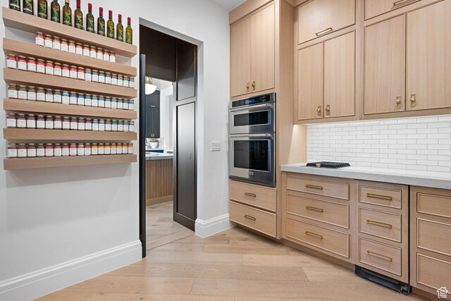 3905 S Quarry Ridge Dr, St George, UT 84790 - kitchen with light hardwood / wood-style floors, light brown cabinetry, double oven, and decorative backsplash