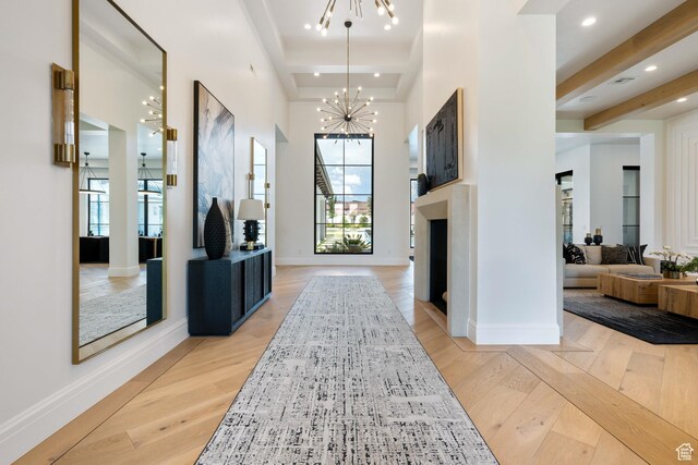 3905 S Quarry Ridge Dr, St George, UT 84790 - entrance foyer with beam ceiling, a towering ceiling, a notable chandelier, and light wood-type flooring